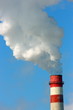 Smoking stack of the thermal power station against a blue sky