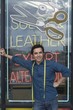 Man standing infront of laundrette shop window