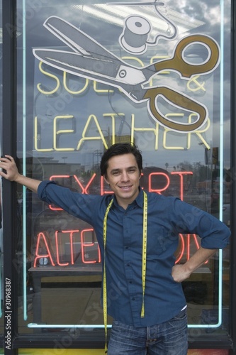 Photo: Man standing infront of laundrette shop window Man standing infront of laundrette shop window