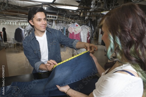Photo: Man serving customer in the laundrette Man serving customer in the laundrette
