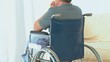Man in a wheelchair looking through the window Man in a wheelchair looking through the window