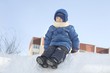 Young boy sitting in the snow