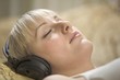 Portrait of a young woman relaxing with headdphones on