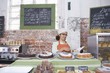 Catering assistant packs take away box in service area of canteen