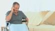 Man in a wheelchair taking on the phone Man in a wheelchair taking on the phone