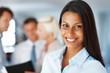 Smart young businesswoman smiling at office