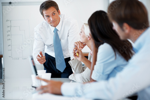 Photo: Young businessman discussing working ideas with colleagues Young businessman discussing working ideas with colleagues