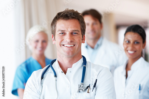 Foto: Young doctor standing in frount of his team Young doctor standing in frount of his team