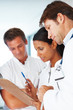 Doctors  together and discussing on medical report