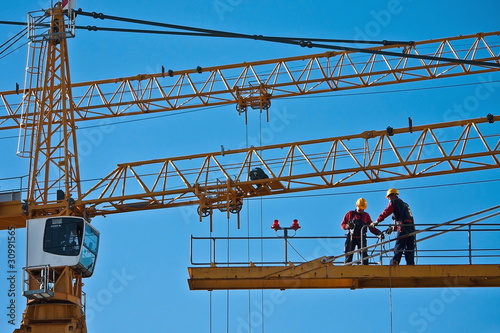 Photo: Worker on the top of a crane Worker on the top of a crane