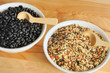Bowls of uncooked wild rice and black beans
