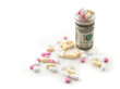 Pills in a bottle made of money