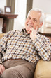 Senior Man Relaxing In Chair At Home