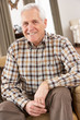 Senior Man Relaxing In Chair At Home