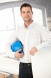 Young architect smiling in office Young architect smiling in office