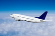 Airplane in the sky, over the cloudy sky