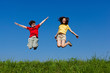Girl and boy jumping, running against blue sky Girl and boy jumping, running against blue sky
