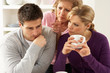 Photo: Senior Mother Interferring With Couple Having Argument At Home Senior Mother Interferring With Couple Having Argument At Home
