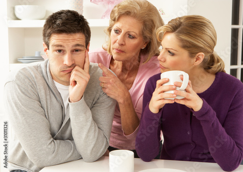 Photo: Senior Mother Interferring With Couple Having Argument At Home Senior Mother Interferring With Couple Having Argument At Home