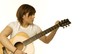 Photo: Woman Tuning A Guitar Woman Tuning A Guitar