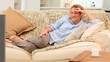 Casual woman laughing in front of her tv