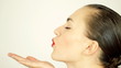 Video: Profile view of a young woman blowing a kiss Profile view of a young woman blowing a kiss