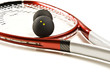Close up of a red and silver squash racket and ball