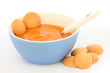 Red bowl with children fruit pap / mush with sponge-biscuits