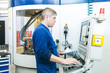 worker operating CNC machine center