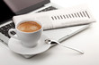 Cappuccino cup with laptop and newspaper