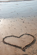 heart drawn in the sand on the beach