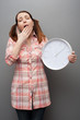 yawning woman holding clock yawning woman holding clock