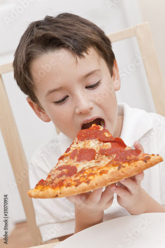 Photo: Young Boy Child Eating Slice of Pizza Young Boy Child Eating Slice of Pizza