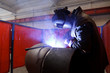 worker weld metal in factory and sparks