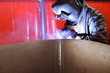 worker weld metal in factory and sparks