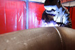 worker weld metal in factory and sparks