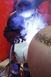 worker weld metal in factory and sparks