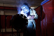 worker weld metal in factory and sparks