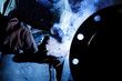 worker weld metal in factory and sparks