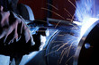 worker weld metal in factory and sparks
