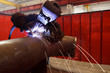 worker weld metal in factory and sparks