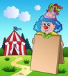 Clown holding board near tent Clown holding board near tent