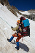 Mountaineer girl moving down on rope