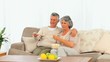 Video: Mature couple eating popcorn in front of the tv Mature couple eating popcorn in front of the tv