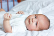 Cute little child is lying on the sheet