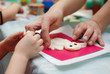 Child mother hands making dough toy