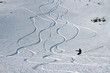 Snowborder leaving new track on snow powder