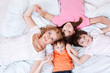Mother and three kids lying