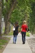 Friends Walking On The Sidewalk
