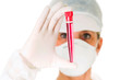 female doctor with mask holding a test tube